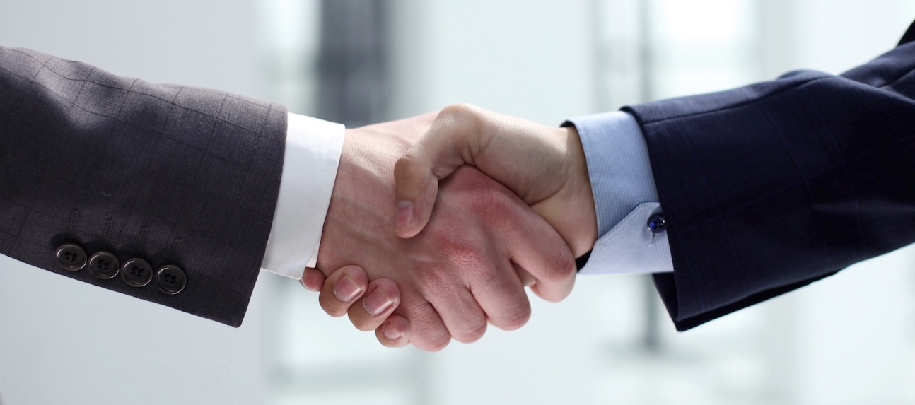 Handshake,,Agreement,After,The,Transaction 2 men shaking hands after the transaction